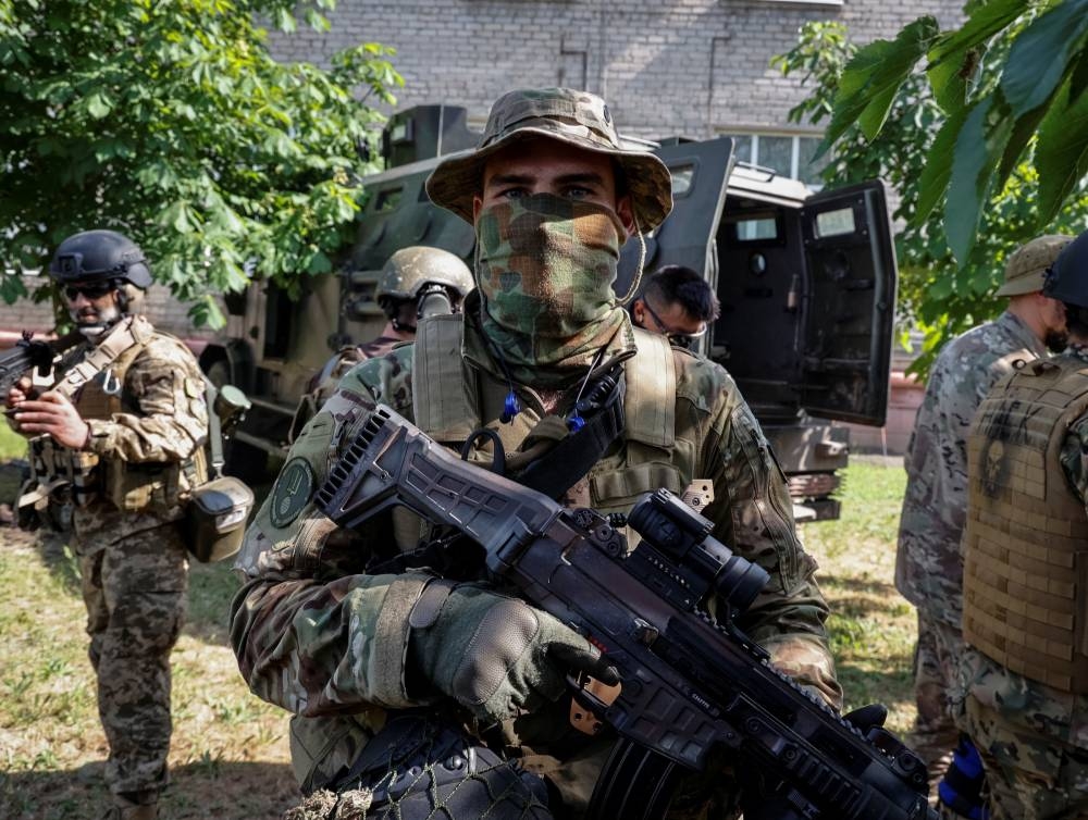 Members of the foreign volunteers unit which fights in the Ukrainian army look on, as Russia's attack on Ukraine continues, in Sievierodonetsk, Luhansk region Ukraine June 2, 2022. — Reuters pic