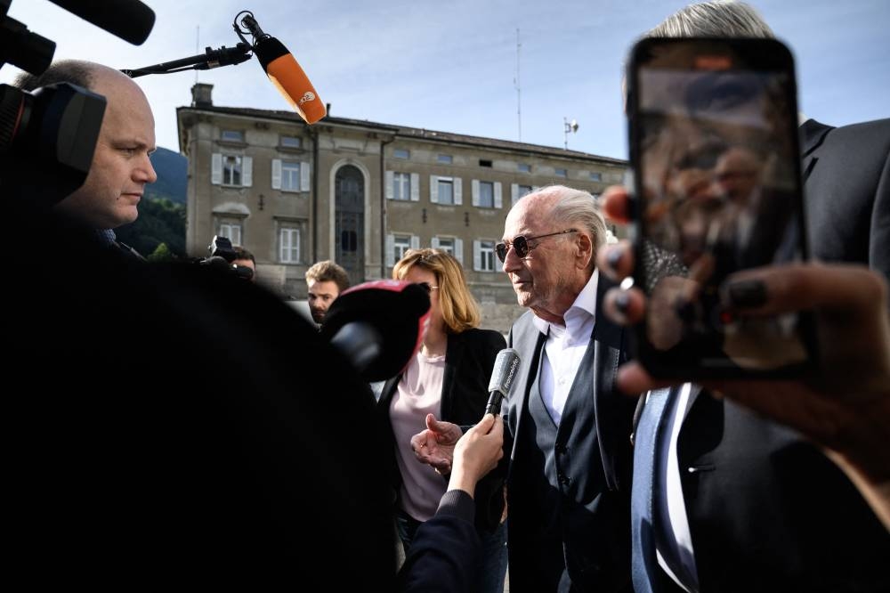 Former Fifa president Sepp Blatter talks to the press as he arrives to Switzerland’s Federal Criminal Court for the start of his trial over a suspected fraudulent payment, June 8, 2022 in the  southern city of Bellinzona. — AFP pic 