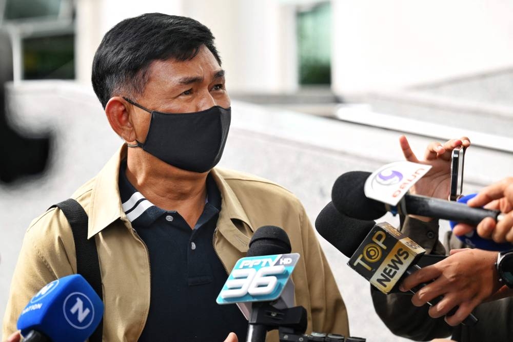 Jakkrit Klandee, father of Jirapong Thanapat, speaks to the press as he arrives at the Central Criminal Court for Corruption and Misconduct before the ruling against former Nakhon Sawan province district police station chief Thitisan Utthanaphon, nicknamed ‘Joe Ferrari’, in Bangkok on June 8, 2022. — AFP pic