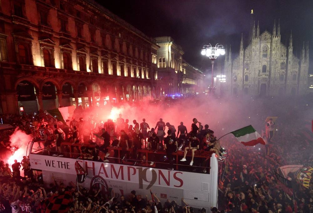 AC Milan fans celebrate with the team during the victory parade after winning the Serie A in Milan, May 23, 2022. — Reuters pic 