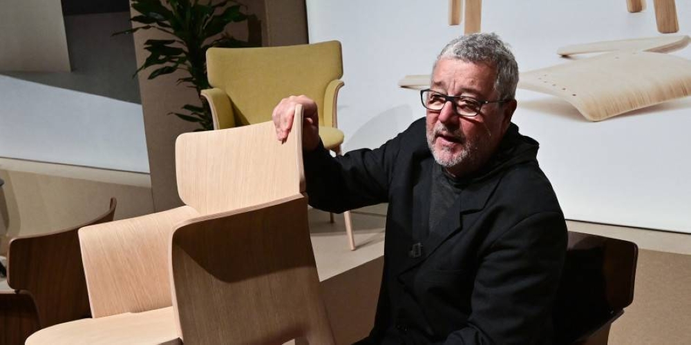 French designer Philippe Starck in 2021 holding one of the chairs he designed at the Andreu World stand. — AFP pic