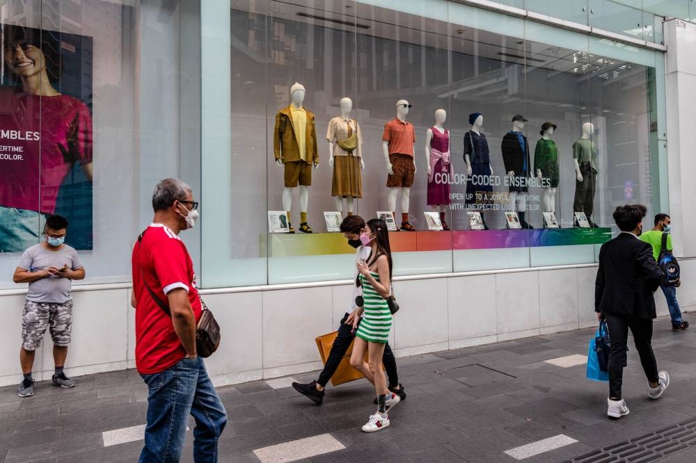 People are seen wearing protective masks as they walk along the Bukit Bintang shopping area in Kuala Lumpur May 19, 2022. ― Picture by Firdaus Latif