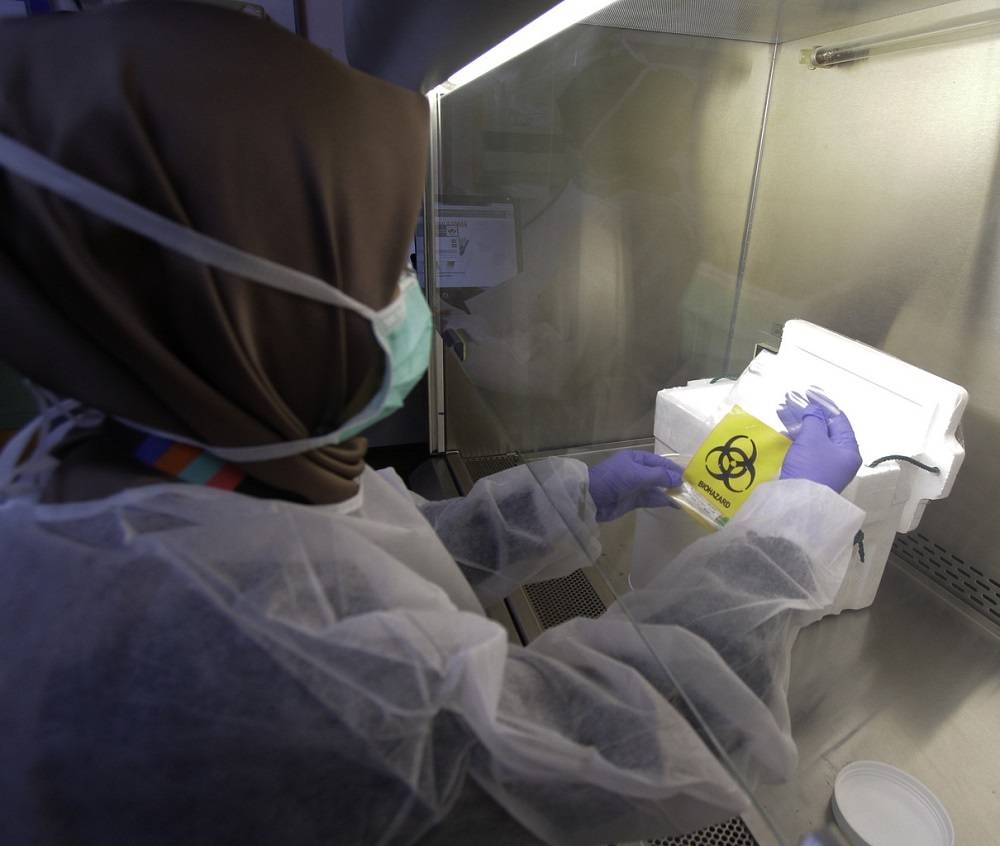 A lab technician processes a test sample during a screening process for the Covid-19 virus, at the Institute for Medical Research in Kuala Lumpur February 26, 2020. — Bernama pic