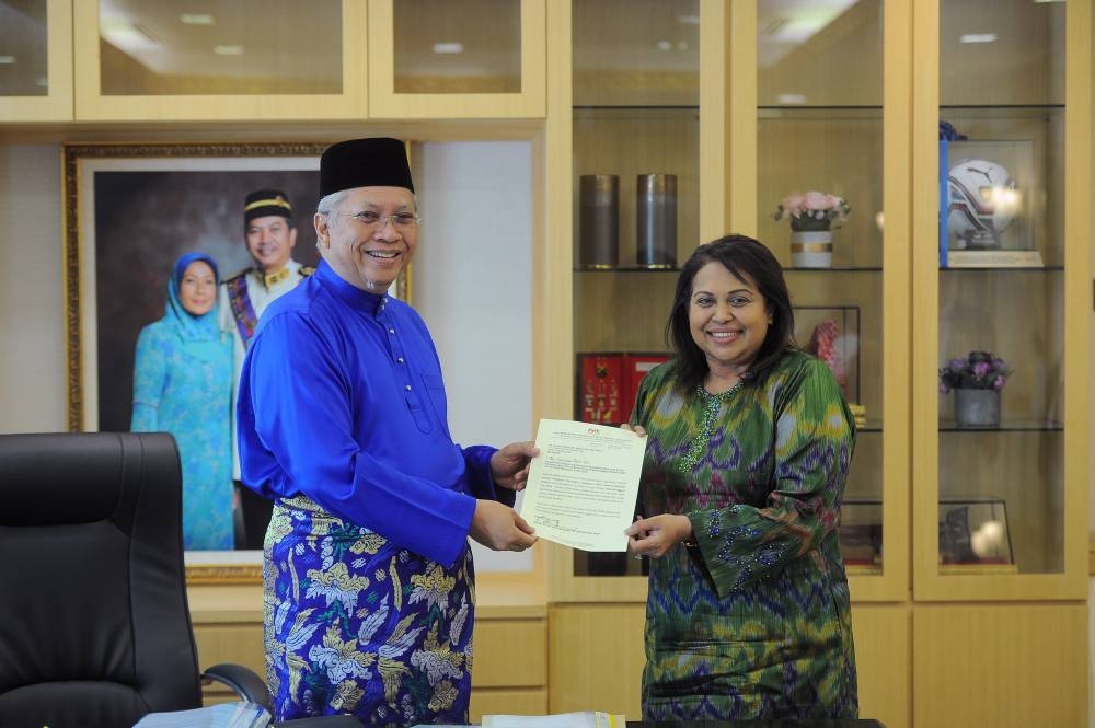 Communications and Multimedia Minister Tan Sri Annuar Musa (left) hands the letter of appointment to the new chairman of the National Film Development Corporation Malaysia (Finas) Senator Datuk Seri Zurainah Musa  in Putrajaya June 10, 2022. — Bernama pic