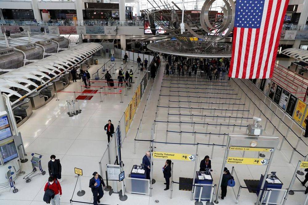 Passengers walk through Terminal 1 at JFK International Airport in New York March 13, 2020. ― Reuters pic