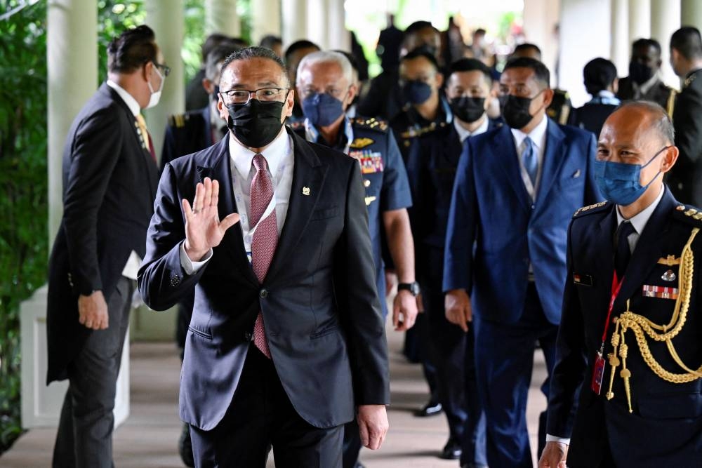 Malaysia’s Senior Minister for Defence, Datuk Seri Hishammuddin Hussein (left) gestures while on his way to attend the U.S. Multilateral Meeting with Southeast Asia Defence Ministers at the 19th Shangri-La Dialogue in Singapore June 10, 2022. — Reuters pic