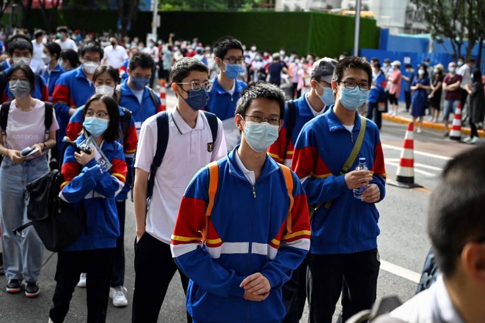 File photo of students entering a school to sit for the first day of the National College Entrance Examination, known as ‘gaokao’, in Beijing on June 7, 2022. — AFP pic