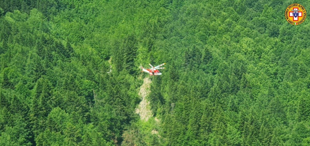 An Alpine Rescue helicopter flies over helicopter crash site near Pievepelago, Italy, June 11, 2022. — Reuters pic