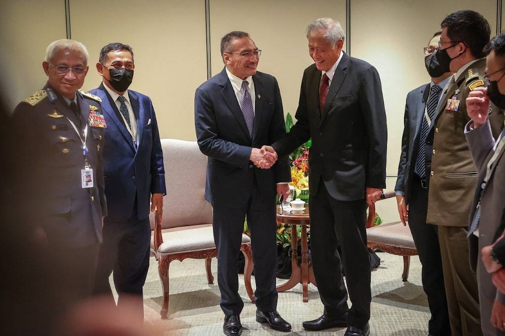 Senior Minister of Defence Datuk Seri Hishammuddin Hussein greets his Singapore counterpart Dr Ng Eng Hen during his working visit to Singapore June 11, 2022. — Picture via Facebook/Hishammuddin Hussein