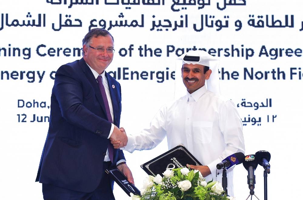 Qatar's Minister of State for Energy Affairs and President and CEO of QatarEnergy Saad Sherida al-Kaabi (right) and French energy group TotalEnergies CEO Patrick Pouyanne attend a signing ceremony at the QatarEnergy headquarters in Doha on June 12, 2022. — AFP pic
