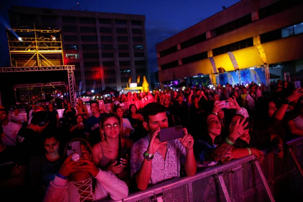 People attend an urban music festival housed in the open parking lot of a shopping centre in Caracas, Venezuela June 4, 2022. — Reuters pic
