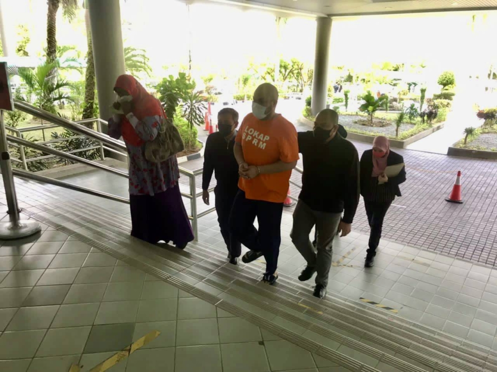 The 43-year-old suspect was arrested after he showed up at the Selangor headquarters of the Malaysian Anti-Corruption Commission (MACC) in Shah Alam at 8pm yesterday to give his statement. — Picture courtesy of the Johor MACC 
