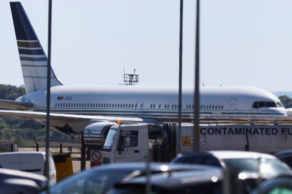 A plane reported by British media to be first to transport migrants to Rwanda is seen on the tarmac at MOD Boscombe Down base in Wiltshire June 14, 2022. — Reuters pic