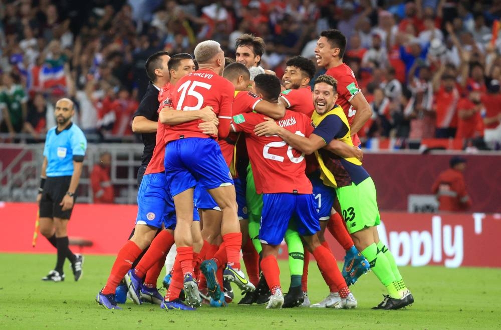 Costa Rica players celebrate after qualifying for the Qatar 2022 Fifa World Cup at the Al Rayyan Stadium in Qatar June 14, 2022. — Reuters pic