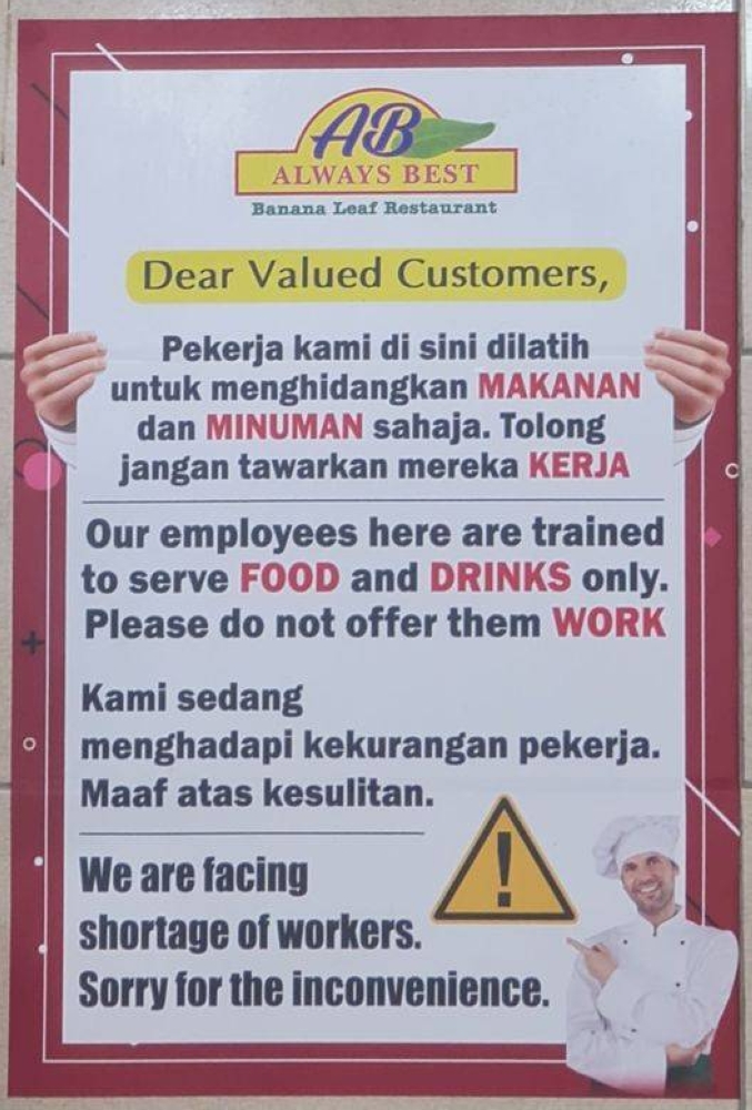 A Bandar Bukit Tinggi restaurant owner has resorted to putting up posters to appeal to employers not to 'pinch' his workers. — Picture via Facebook/ Alfred Samuel Mariyaras