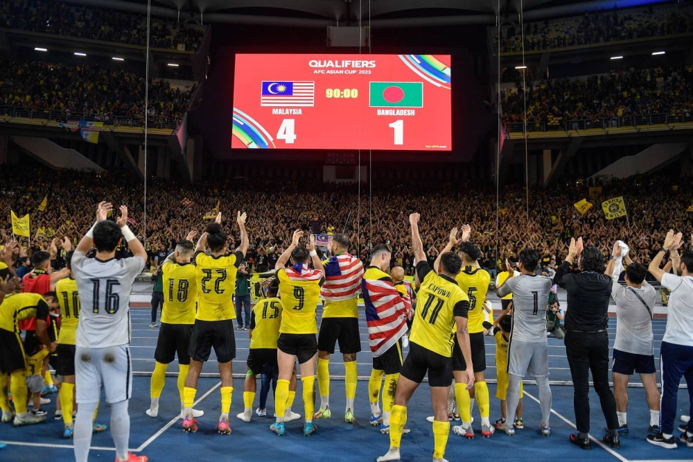 The Harimau Malaya squad celebrates their win after defeating Bangladesh during the Group E match of the 2023 Asian Cup Qualifiers at the Bukit Jalil National Stadium, June 14, 2022. — Bernama pic   