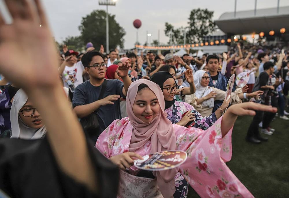 Malaysian Muslim women wearing traditional yukatas dance on the stage during Bon Odori Festival in Shah Alam July 21, 2018. — Picture by Azneal Ishak