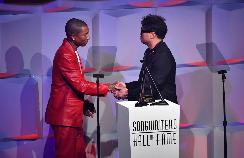 US musicians Pharrell Williams and Chad Hugo greet each other before speaking onstage during the Songwriters Hall of Fame 51st Annual Induction and Awards Gala in New York, June 16, 2022. — AFP pic 