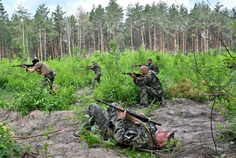 Ukrainians train with army in Bucha base abandoned by Russia