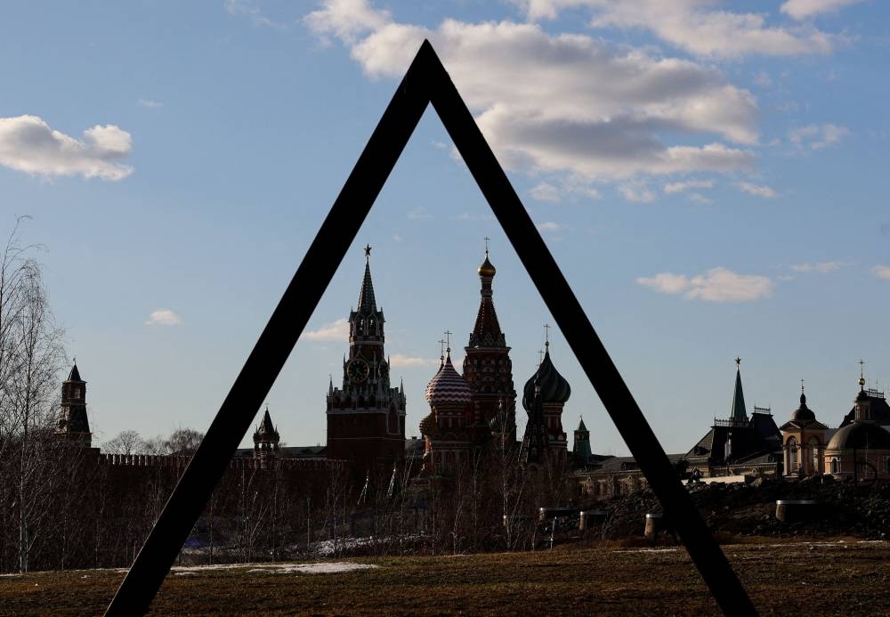 The Kremlin’s Spasskaya Tower and St. Basil’s Cathedral are seen through the art object in Zaryadye park in Moscow, Russia March 15, 2022. ― AFP pic