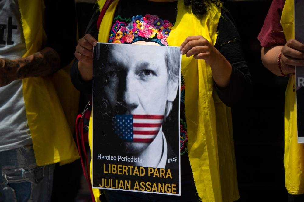 A woman holds a poster depicting WikiLeaks founder, Australian Julian Assange, reading ‘heroic journalist. Freedom for Julian Assange’, during a protest outside the UK embassy in Mexico City, on June 18, 2022, after the UK government approved his extradition to the United States. — AFP pic