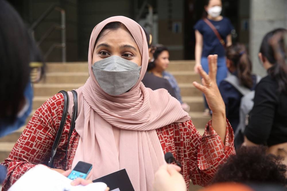 Ummal Remiza Khaja Mohideen speaks to the media outside the National Registration Department headquarters in Putrajaya on June 10, 2022. — Picture by Choo Choy May