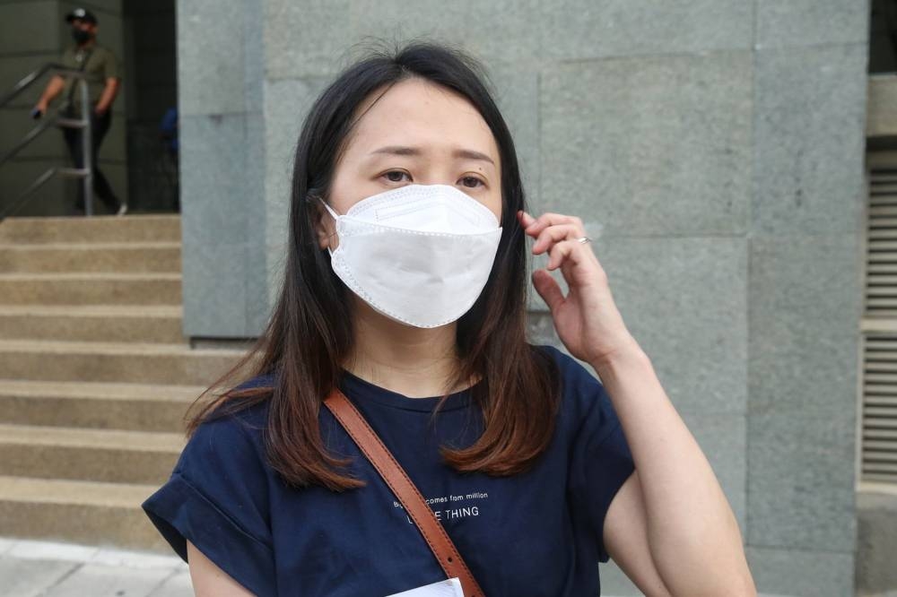 Esther Teo speaks to the media outside the National Registration Department headquarters in Putrajaya on June 10, 2022. — Picture by Choo Choy May