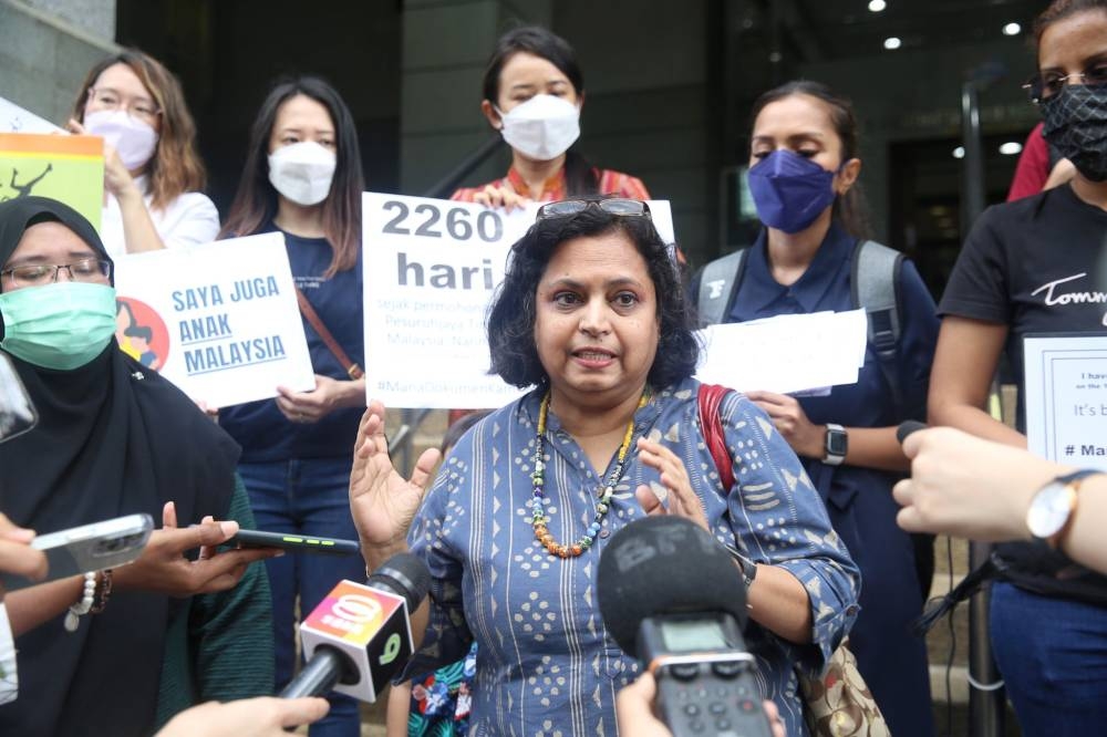 Family Frontiers lead coordinator Bina Ramanand (centre) speaks to the press outside the National Registration Department headquarters in Putrajaya on June 10, 2022. — Picture by Choo Choy May