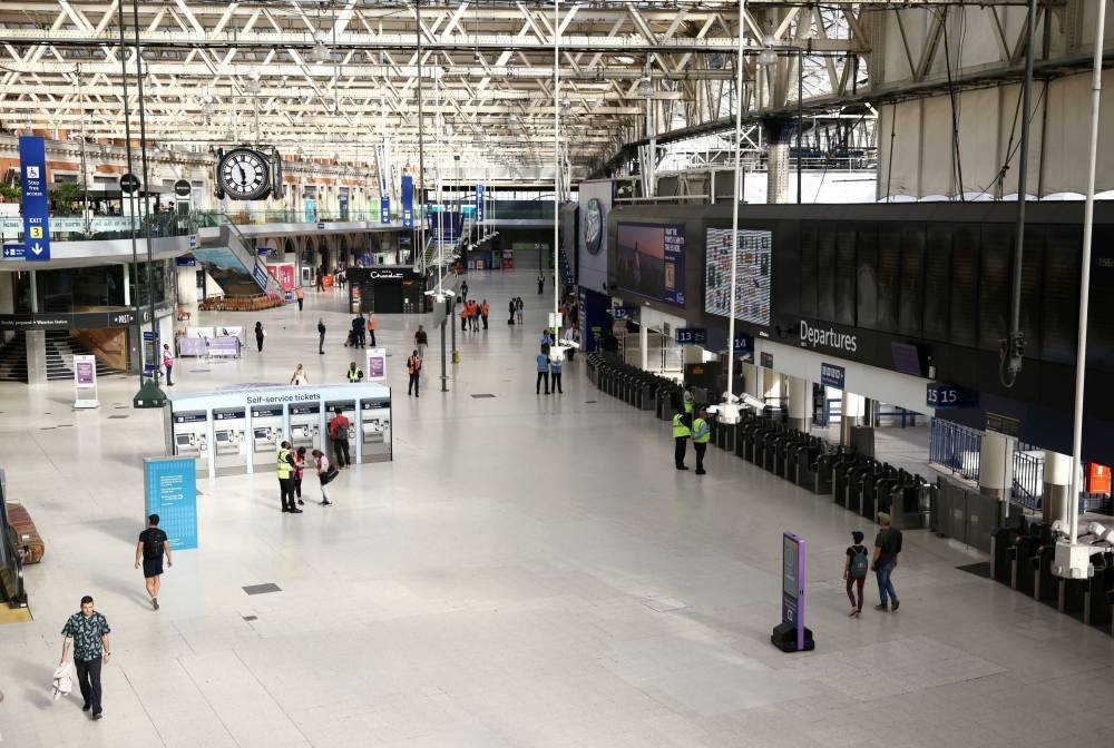 Passengers walk through Waterloo station following train service ending early, on the first day of national rail strike in London, Britain June 21, 2022. ― Reuters pic