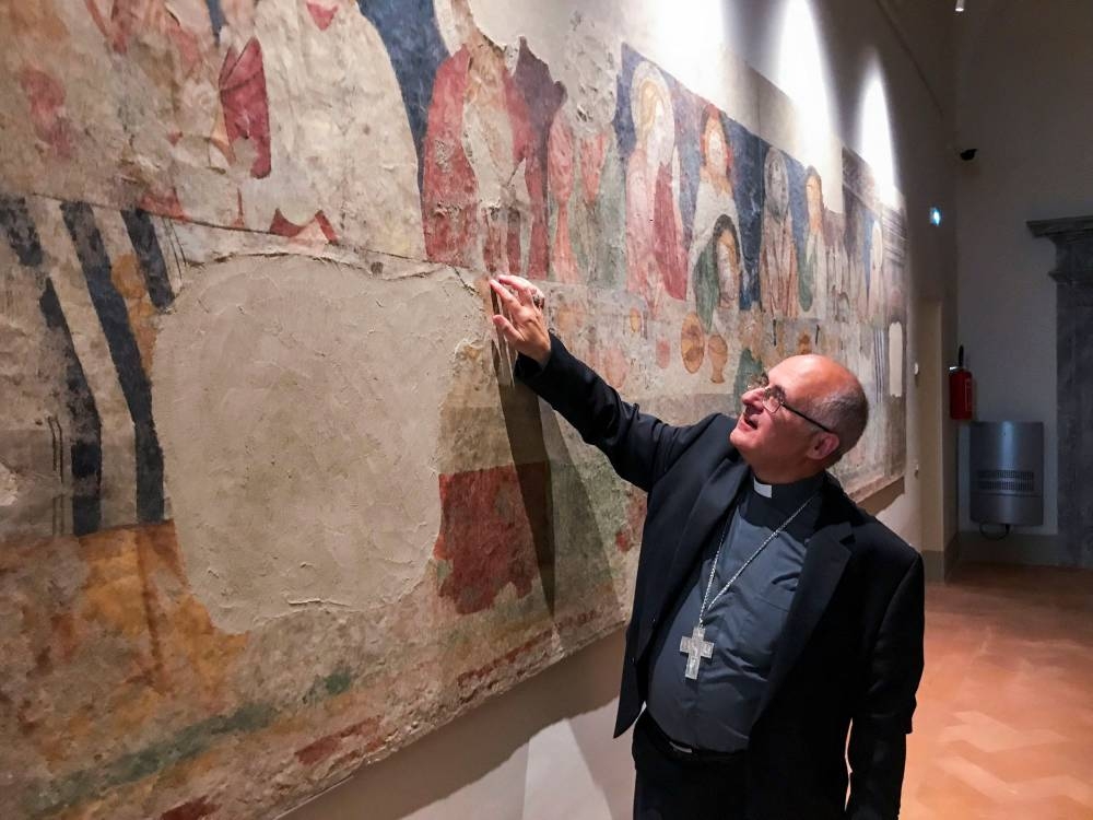Archbishop Francesco Massera points to a fresco at a new museum for art recovered and restored from churches damaged in a series of earthquakes in central Italy in 2016, in San Severino Marche, Italy June 11, 2016. — Reuters pic