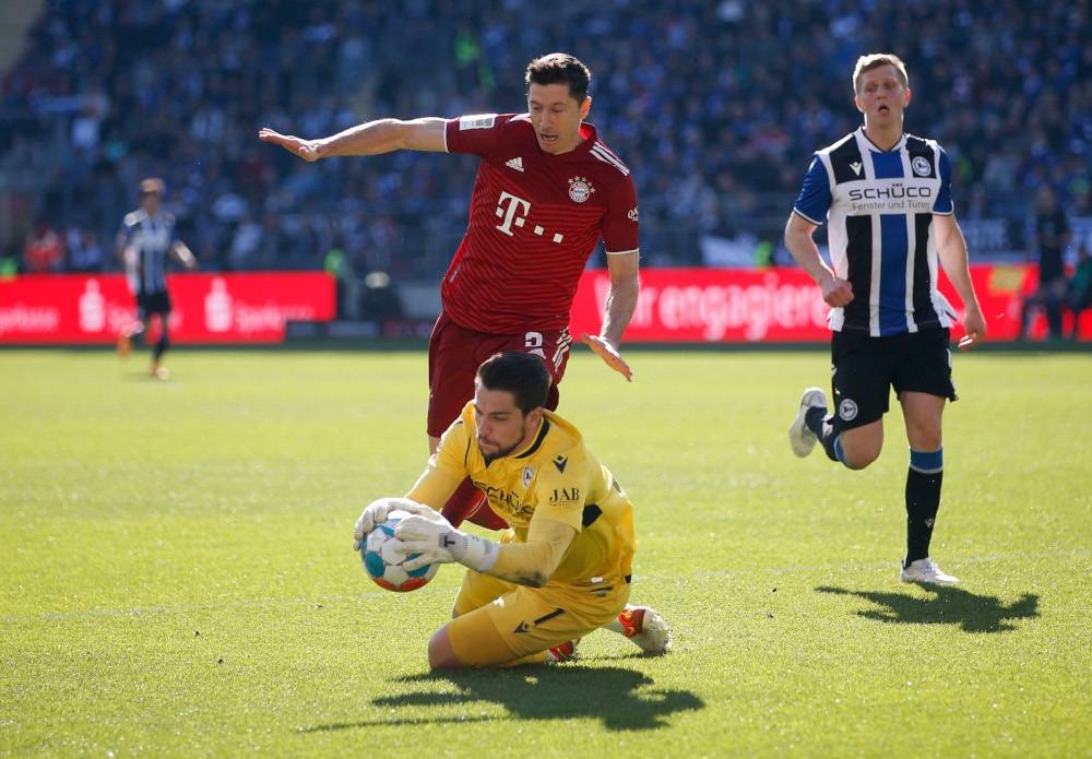 Bayern Munich’s Robert Lewandowski in action with Arminia Bielefeld’s Stefan Ortega at Bielefelder Alm, Bielefeld, Germany, April 17, 2022. — Leon Kuegeler/Action Images via Reuters 