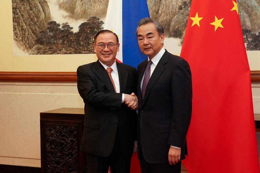 Chinese Foreign Minister Wang Yi meets Philippines Foreign Affairs Secretary Teodoro Locsin Jr at the Diaoyutai State Guesthouse in Beijing in this file photo taken on March 20, 2019. — Andrea Verdelli/Pool pic via Reuters