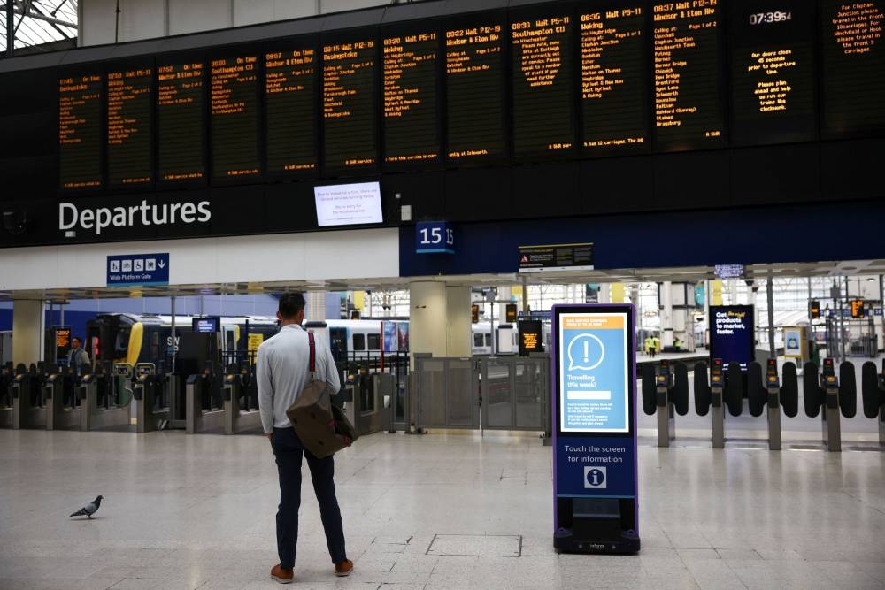 A commuter stands at Waterloo station, on the third day of national rail strikes, in London June 23, 2022. — Reuters pic