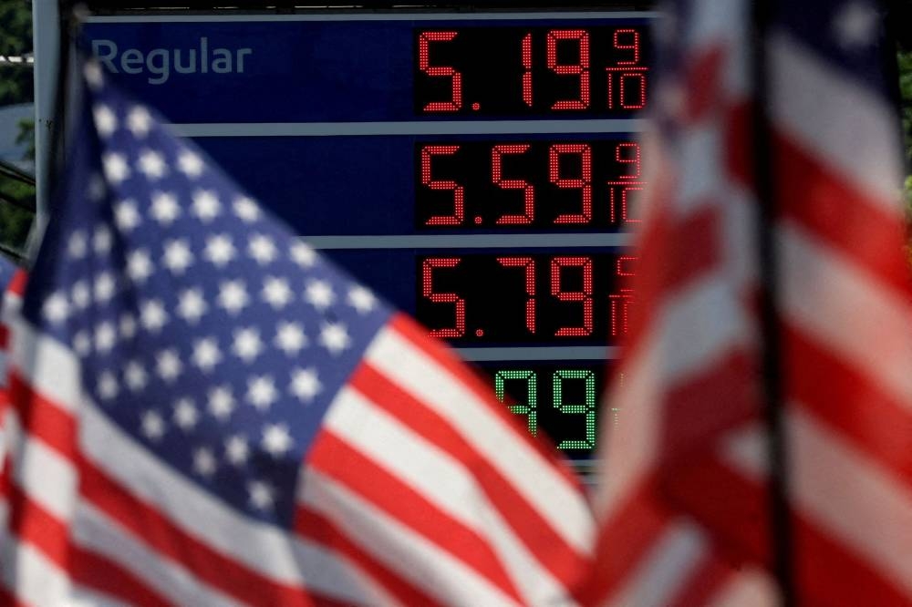 Gasoline prices are displayed at an Exxon gas station behind American flag in Edgewater, New Jersey June 14, 2022. — Reuters pic 