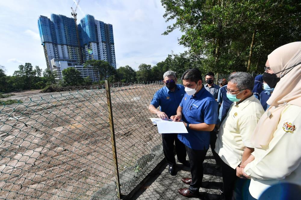 Education Minister Datuk Radzi Jidin (second left) during the ground-breaking ceremony for a project to build an additional block and field for Sekolah Kebangsaan Putrajaya Presint 18(2), in Putrajaya June 25, 2022. — Bernama pic