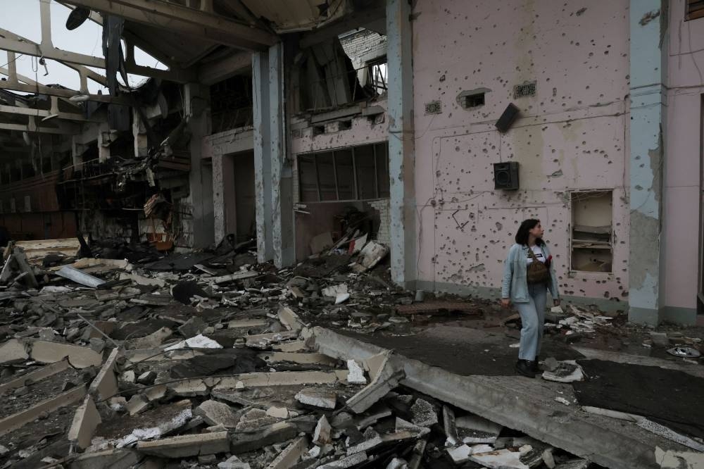 A person surveys the damage after a sports complex of an educational institution was shelled overnight as Russia’s attack on Ukraine continues in Kharkiv, Ukraine, June 24, 2022. — Reuters pic