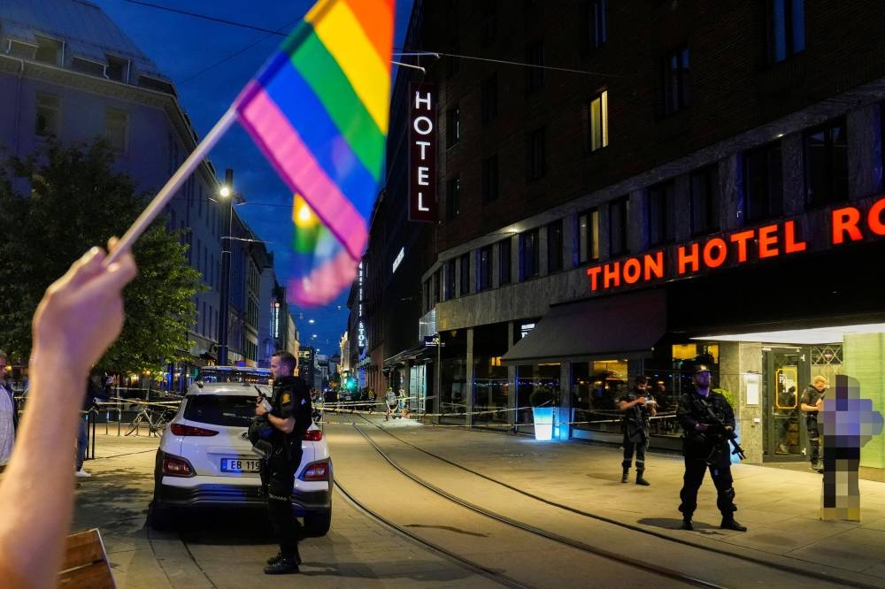 Security forces stand at the site where several people were injured during a shooting outside the London pub in central Oslo, Norway June 25, 2022. — Reuters pic
