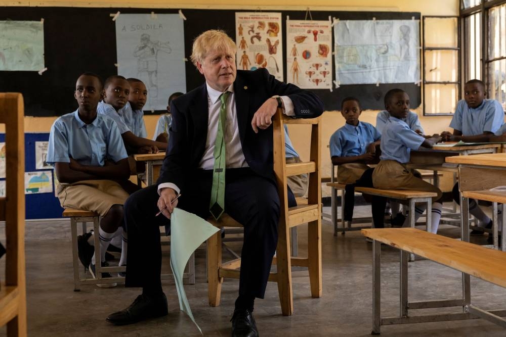 British Prime Minister Boris Johnson attends a lesson during a visit to the GS Kacyiru II school on the sidelines of the Commonwealth Heads of Government Meeting on June 23, 2022 in Kigali, Rwanda. — Reuters pic 