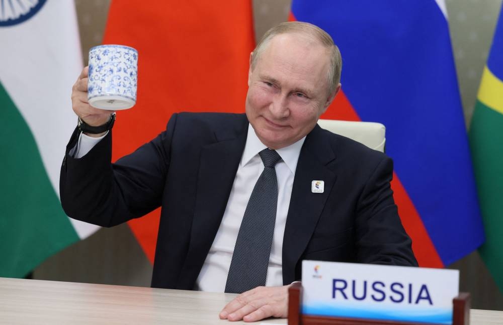 Russian President Vladimir Putin makes a toast as he takes part in the 14th BRICS Summit in virtual format, via video link in the Moscow Region, Russia June 23, 2022. — Reuters pic 