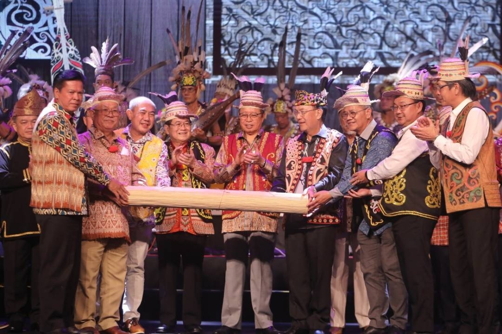 Abang Johari (centre) and the rest witness the handing over of State-level Gawai from the Orang Ulu community led by Gerawat (fourth right) to Datuk John Sikie Tayai representing the Ibans. — Picture by Chimon Upon via Borneo Post