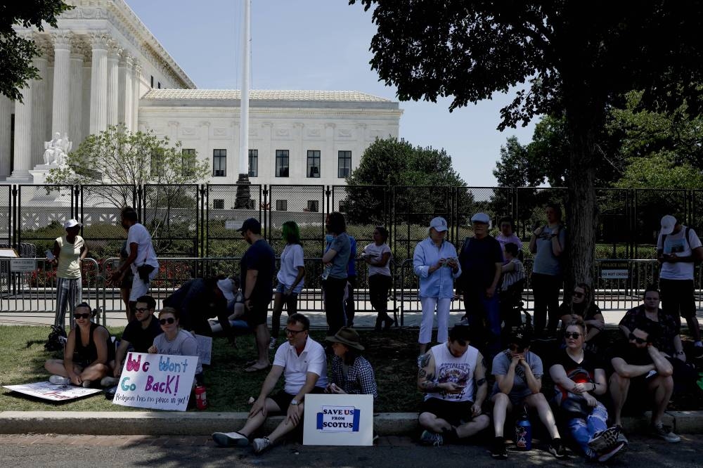 Abortion rights advocates sit in the shade outside of the U.S. Supreme Court on June 26, 2022 in Washington, DC. The Supreme Court's decision in Dobbs v Jackson Women's Health the day before overturned the landmark 50-year-old Roe v Wade case and erased a federal right to an abortion. — Anna Moneymaker/Getty Images/AFP pic