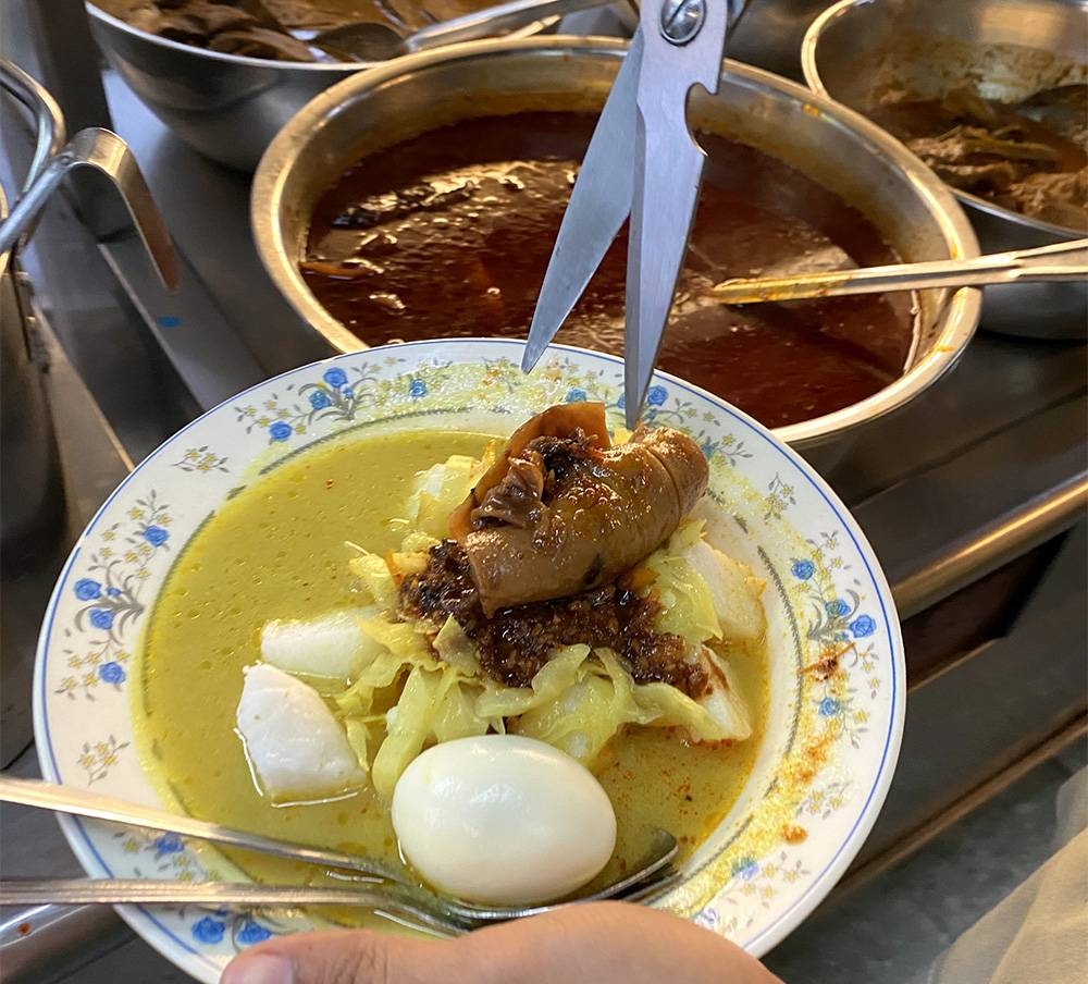 You can also order 'lontong' with 'sayur lodeh' and your choice of protein like this one with 'sambal sotong'.