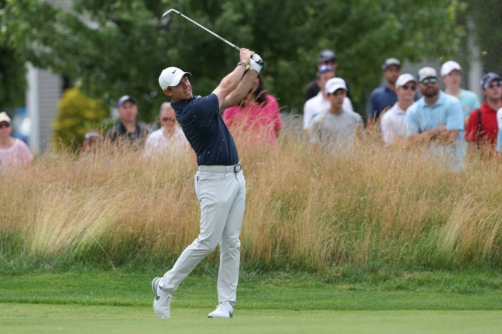 Rory McIlroy plays a shot from the fairway of the seventh hole during the second round of the Travelers Championship golf tournament. — Vincent Carchietta-USA TODAY Sports