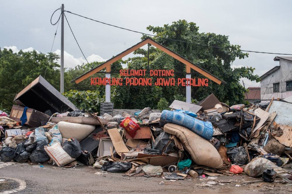Furniture and appliances damaged by floodwaters are seen a makeshift dumpsite in Kampung Padang Jawa in Shah Alam on December 22, 2021. — Picture by Shafwan Zaidon