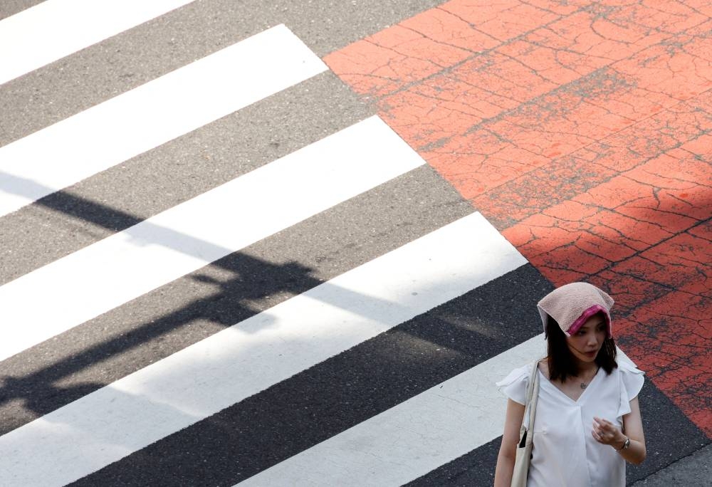 A woman wears a handkerchief on her head during a heatwave in Tokyo, Japan June 27, 2022. ― Reuters pic