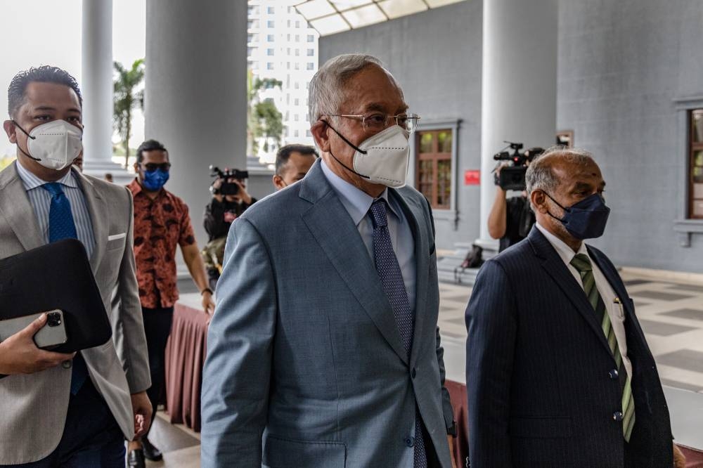 Datuk Seri Najib Razak (centre) arrives at Kuala Lumpur Court Complex on June 23, 2022. — Picture by Firdaus Latif