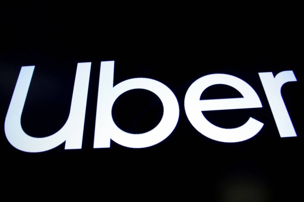 A screen displays the company logo for Uber Technologies Inc. on the day of it's IPO at the New York Stock Exchange (NYSE) in New York May 10, 2019. — Reuters pic