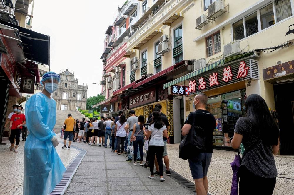 People queue for Covid-19 testing in Macau June 20, 2022. — Reuters pic