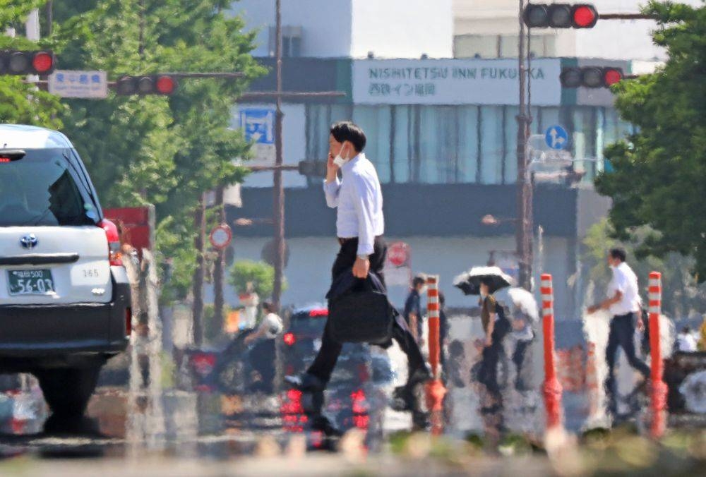 A photo shows a road mirage brought about by a heat wave in Fukuoka City, Fukuoka Prefecture on June 30, 2022. — The Yomiuri Shimbun picture via Reuters