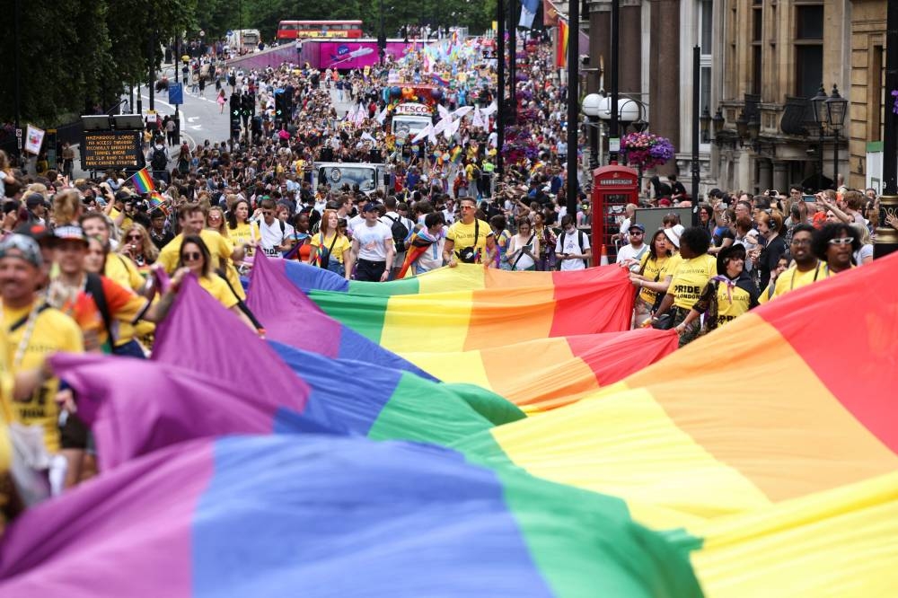 People carry a large rainbow flag, as they take part in the 2022 Pride Parade in London, Britain July 2, 2022. ― Reuters pic